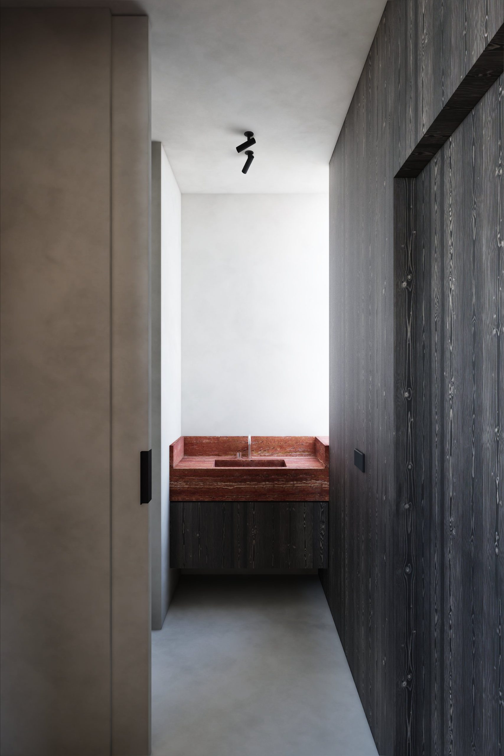 Lavabo in rood travertijn tussen gezwart hout